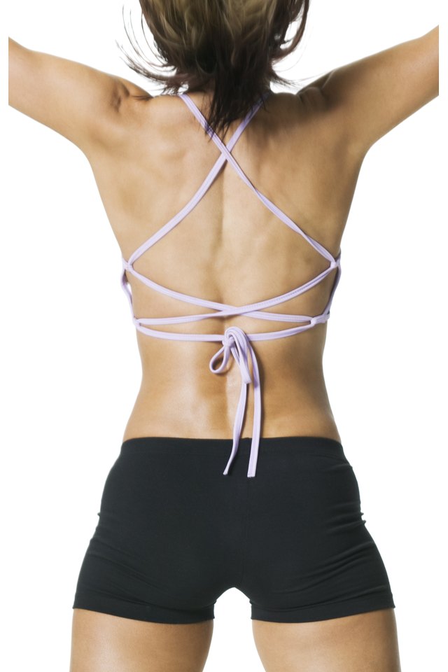 medium shot of the toned back of a young adult woman in a workout outfit