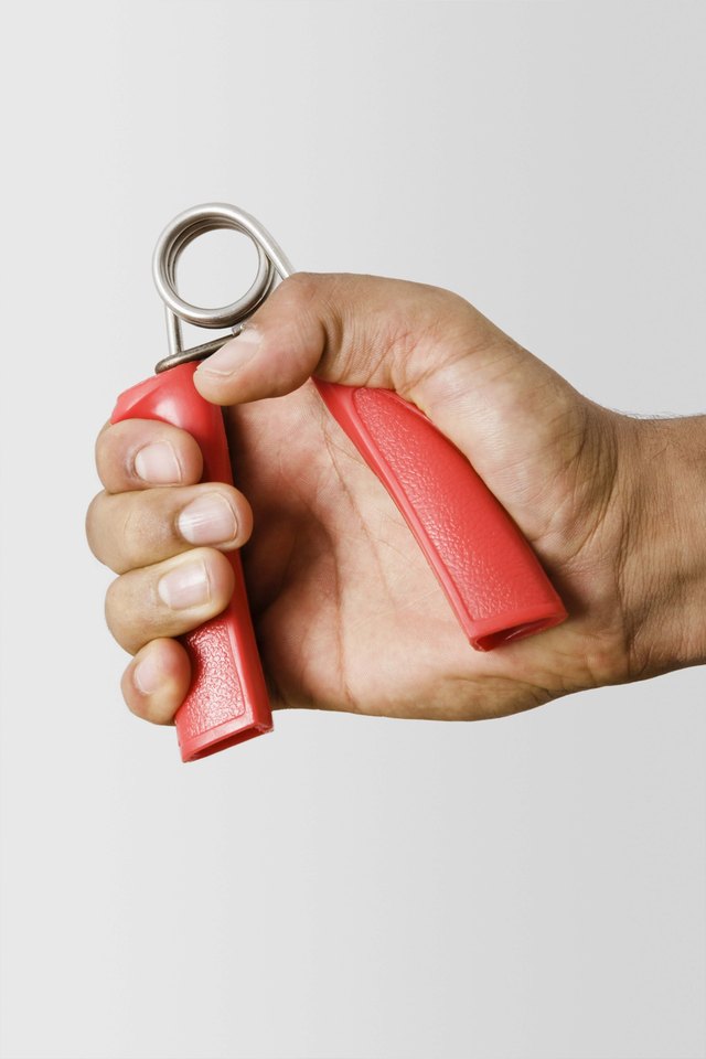 Hand holding exercise gripper