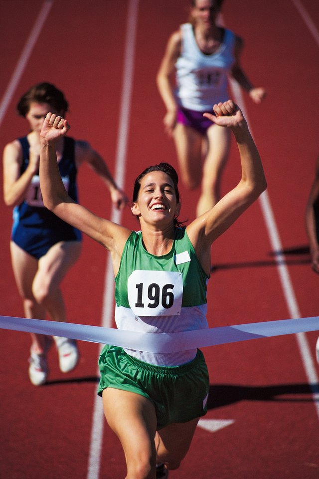 Woman winning race at track meet