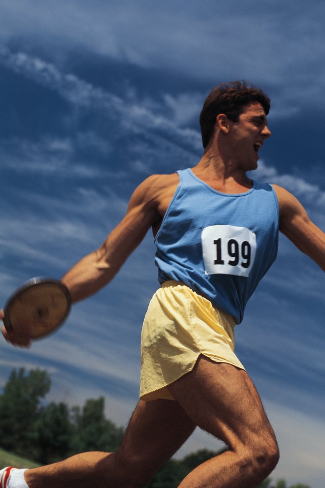 Young man throwing discus