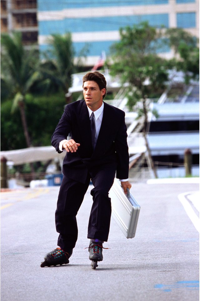a young businessman wearing roller blades and carrying a briefcase