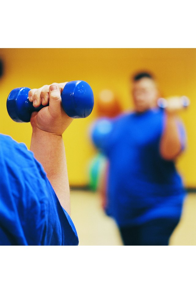 Close Up of an Overweight Man Weight Training in a Gym