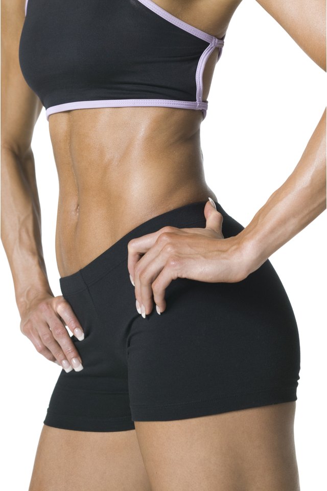 medium shot of the fit body of a young adult woman in a black workout outfit