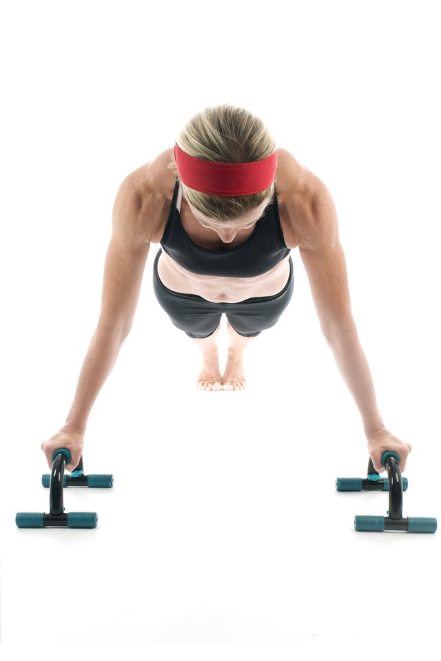 woman exercising doing push up with fitness push up bar front