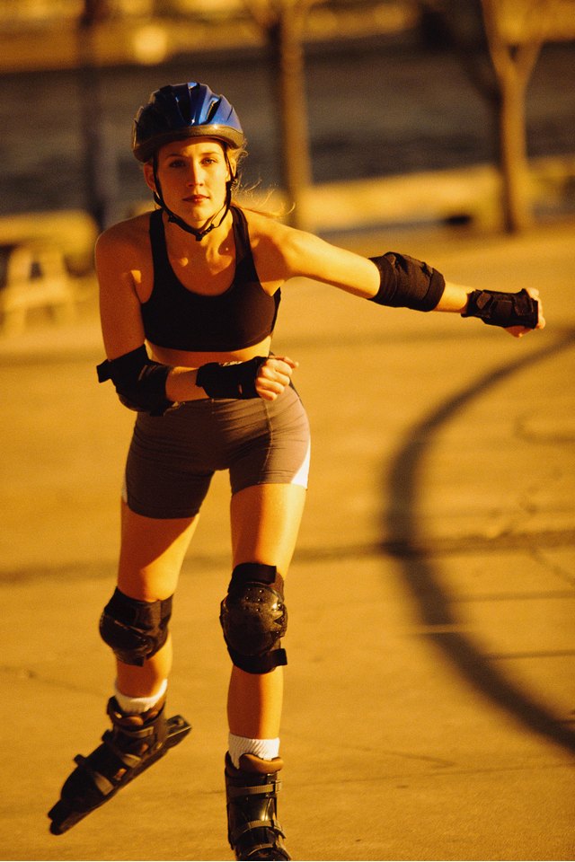 Woman in-line skating along pathway