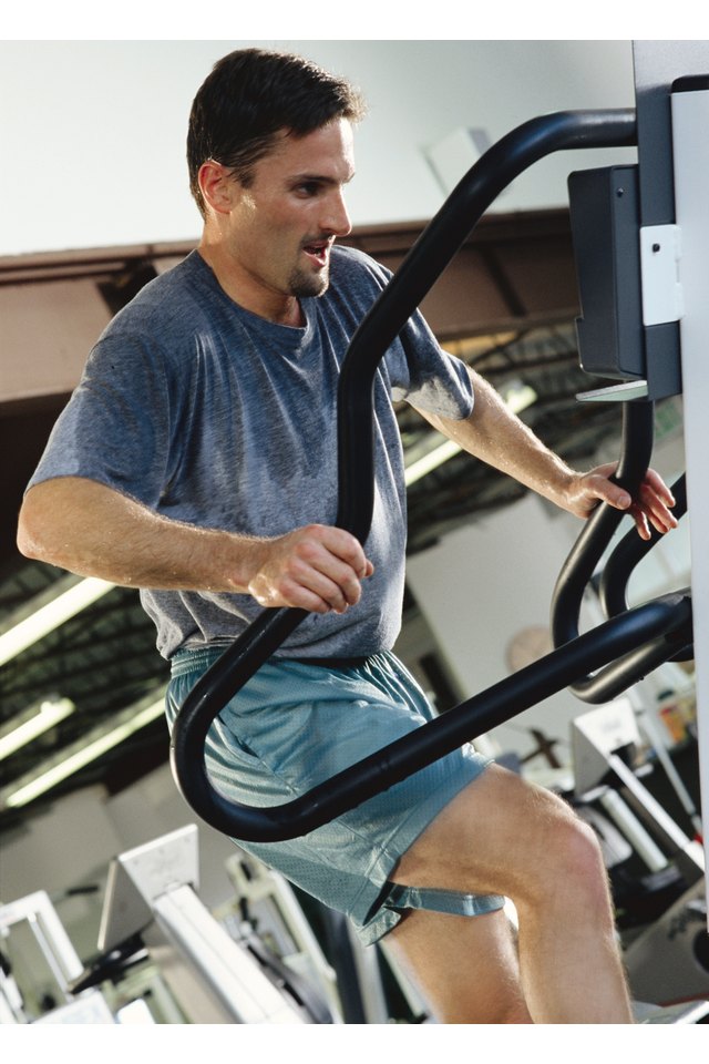 Man stepping stairs in a gym,man working out at the gym on the step exercise machine