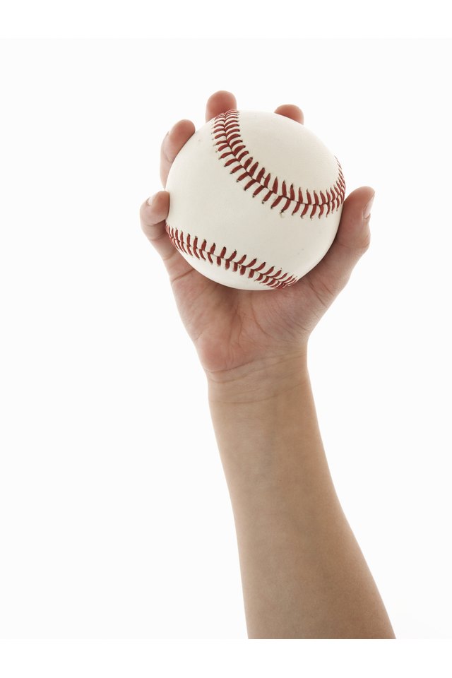 Boy (5-7) holding baseball, close-up of hand
