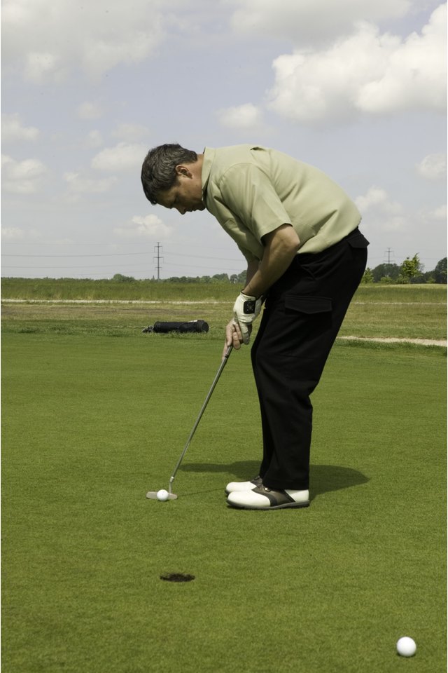 Man putting ball on golf course