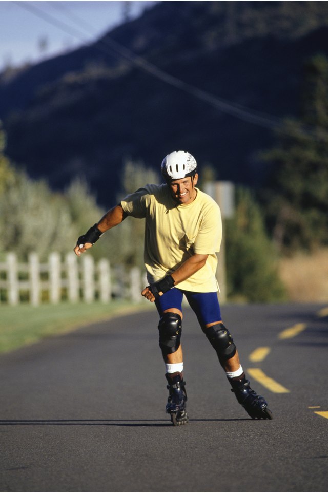Man inline skating on open road