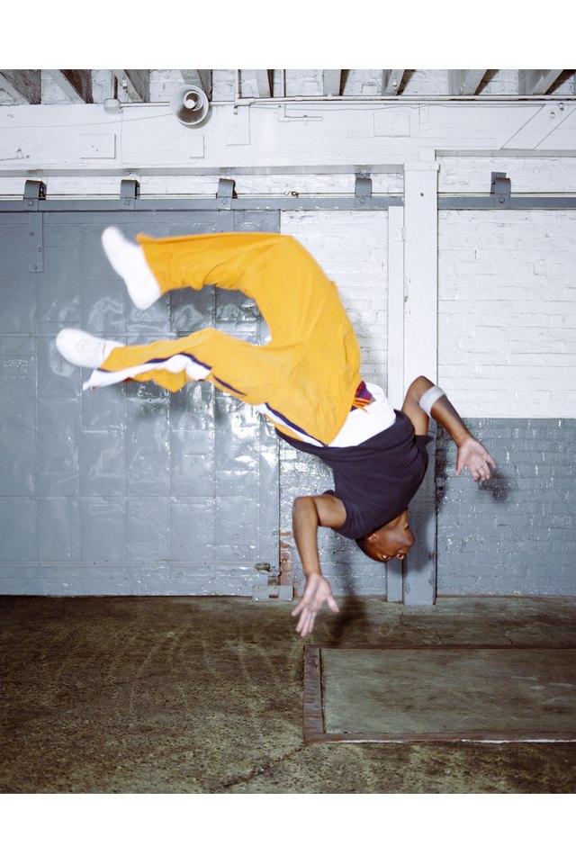 Young male breakdancer doing backflip (blurred motion)