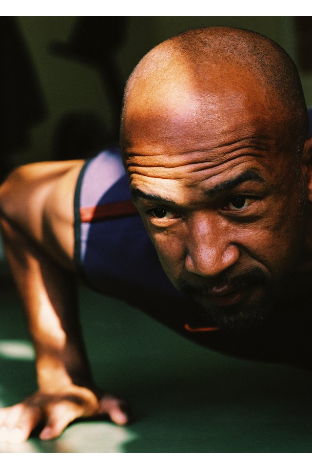 Close-up of a bald man doing push ups