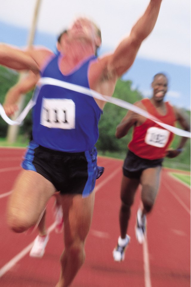 Men reaching finish line of sprint
