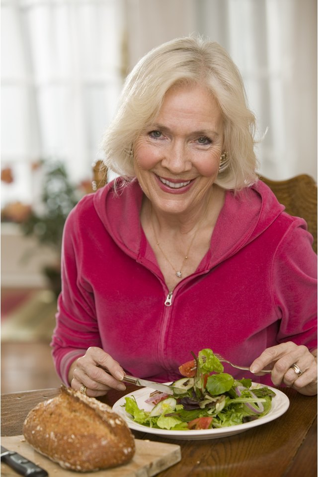 Woman eating salad and bread