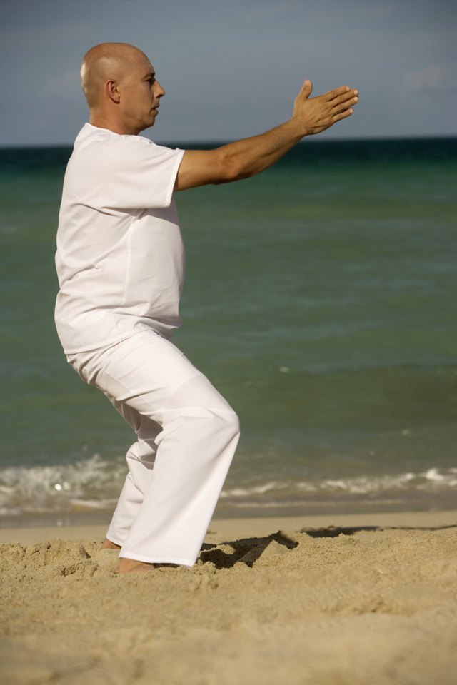 Side profile of a mature man exercising on the beach