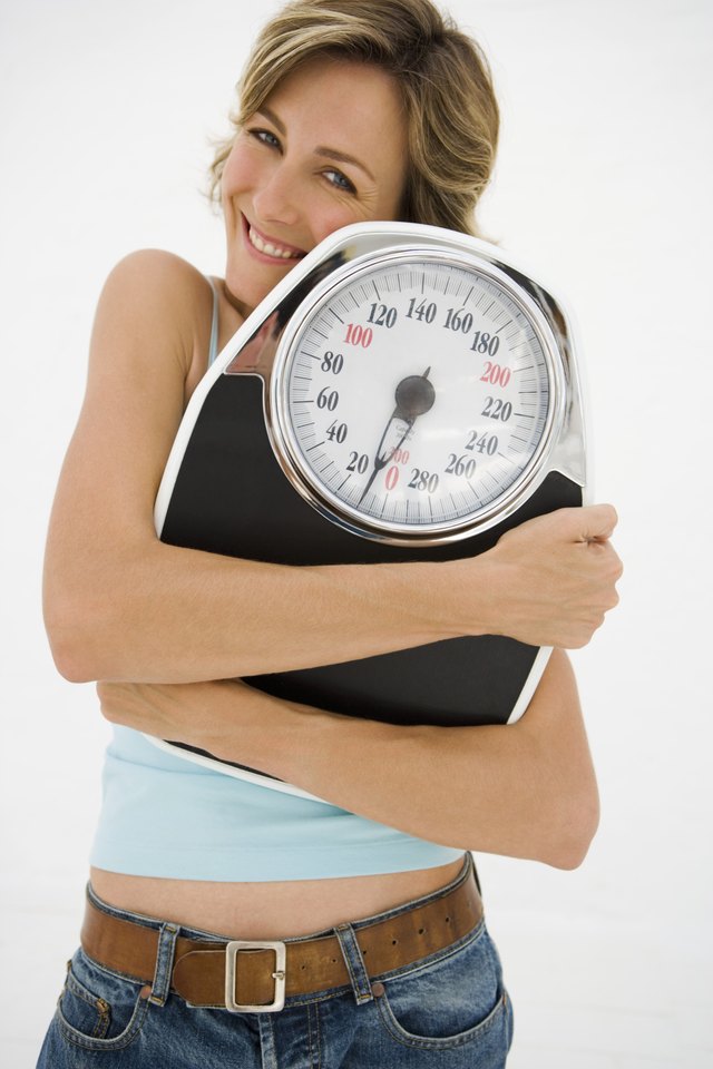 Woman hugging scale