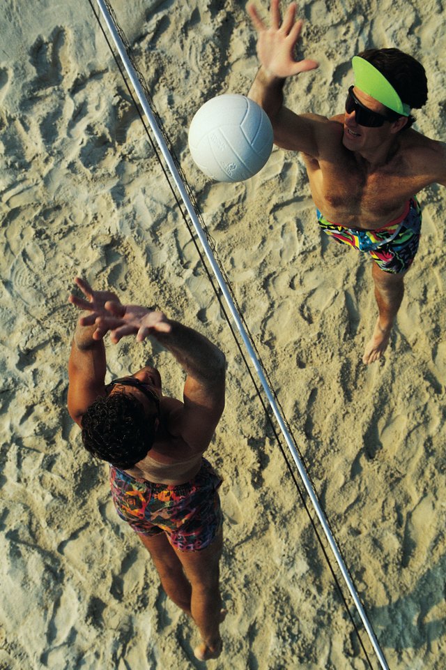 Men playing beach volleyball