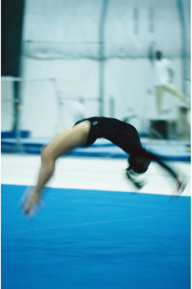 Female Gymnast Doing Back Handspring