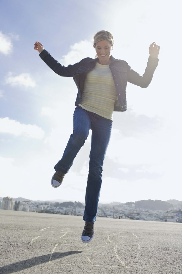 Woman playing hopscotch