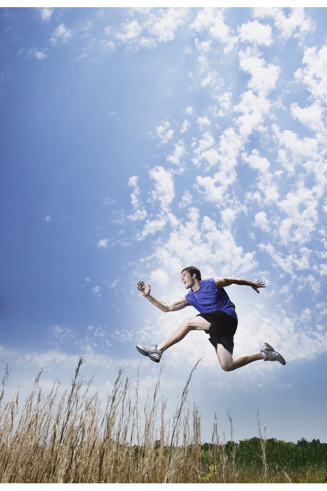 Runner jumping in field