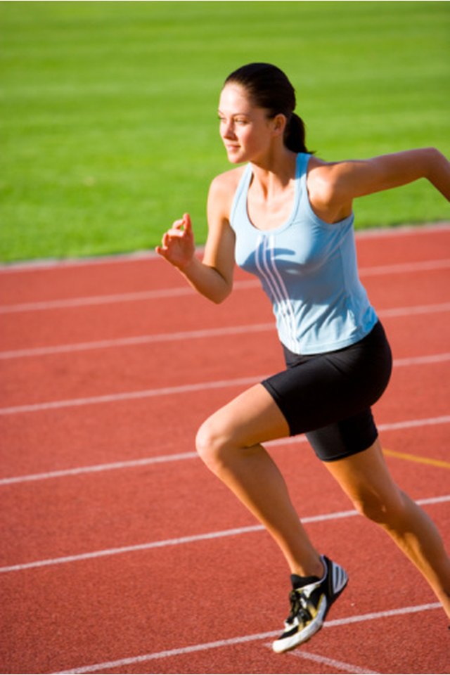 Women Running On Athletic Track by Jupiterimages