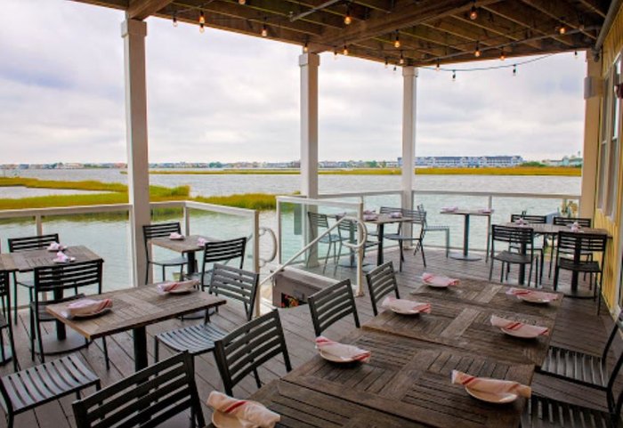 Waterfront dining deck of Catch 54 in Fenwick, Delaware. Catch 54 was awarded the title of best waterfront view in the state and is a stop on Delaware's Culinary Coast trail.