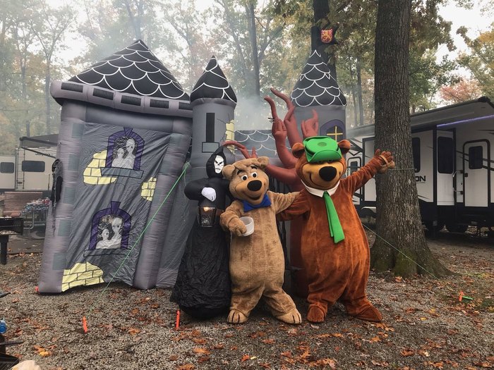 Yogi Bear and Boo Boo stand in front of a haunted castle