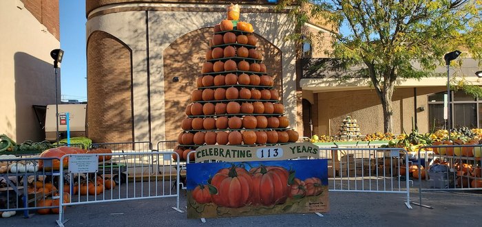 A pyramid of pumpkins with a banner that reads, "Celebrating 113 years"