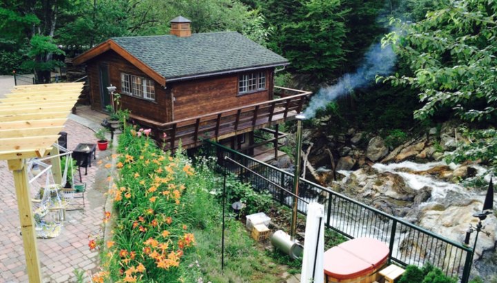 Stay In A Charming Vermont Cottage Situated Right Over A Waterfall