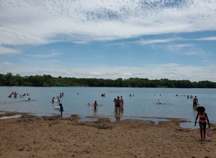 Wade In The Refreshing Waters On The Scenic Beach At Raccoon River In Iowa