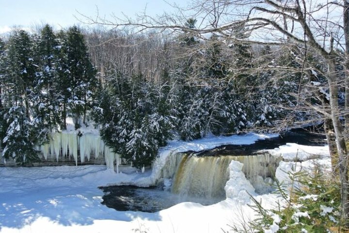 Take A Whimsical Winter Waterfall Trek To The Frozen Tahquamenon Falls In Michigan