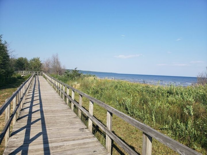 Take A Boardwalk Trail Along The Shoreline Of Manistique Harbor In Michigan