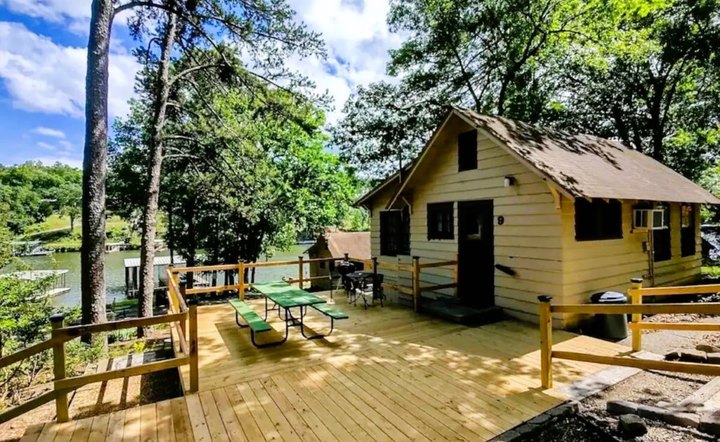 Enjoy A Water-Filled Weekend At This Lakefront Cabin In Arkansas With Its Own Pebble Stone Beach