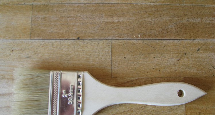 A paint brush can be used to cover wood stain.