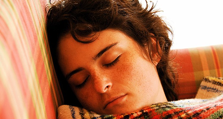 A woman sleeps peacefully before being awakened by her alarm clock