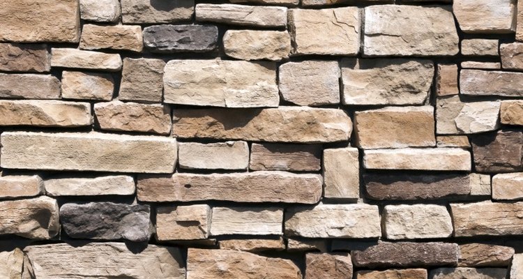Water is the best cleaner for stone walls.