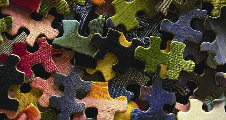 Preserve jigsaw puzzles by sticking them together with glue.