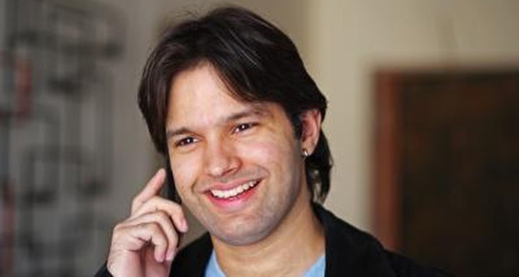 Close up of a man talking on a cell phone.