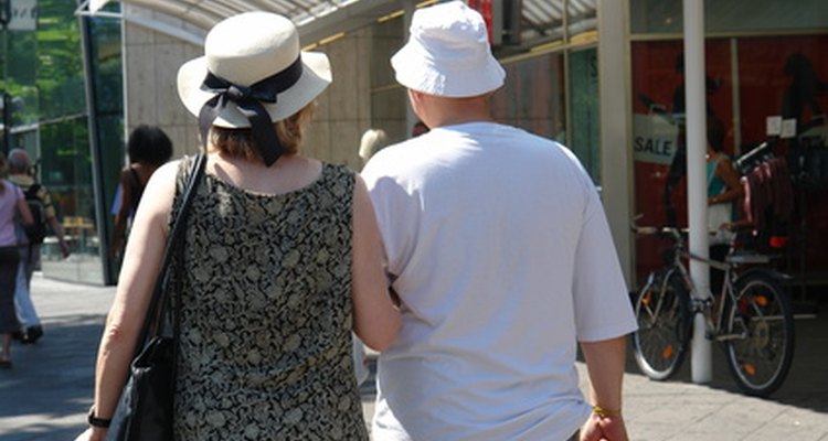 woman holding man's arm as they walk