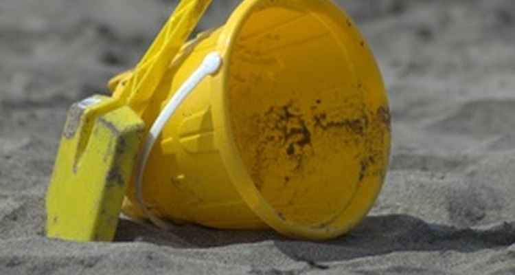 A bucketful of sand is a safe agent to soak up denatured alcohol.