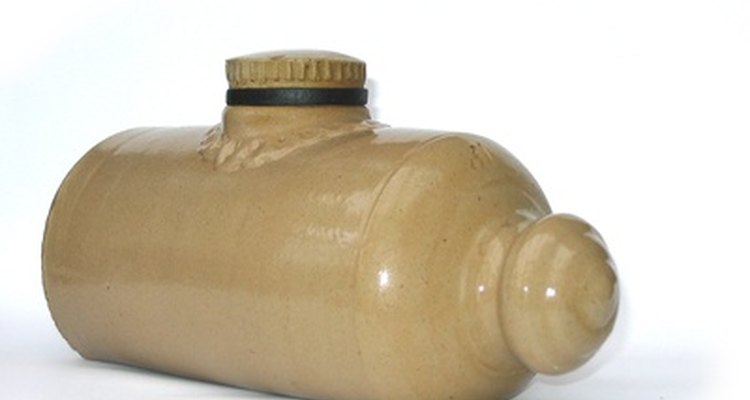 Older hot water bottles were made of ceramic material, but modern bottles are typically made of rubber.