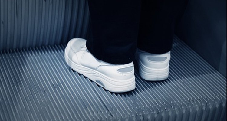 Scuff marks and dirt stand out on white shoes.