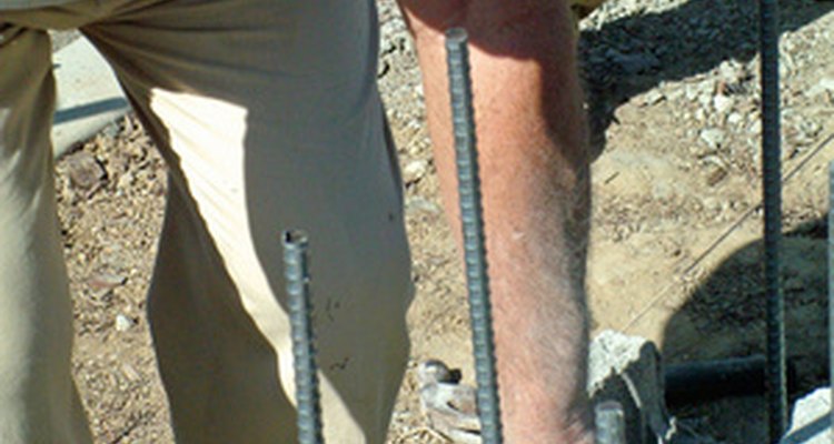 String of stretcher bar visible as mason positions block.