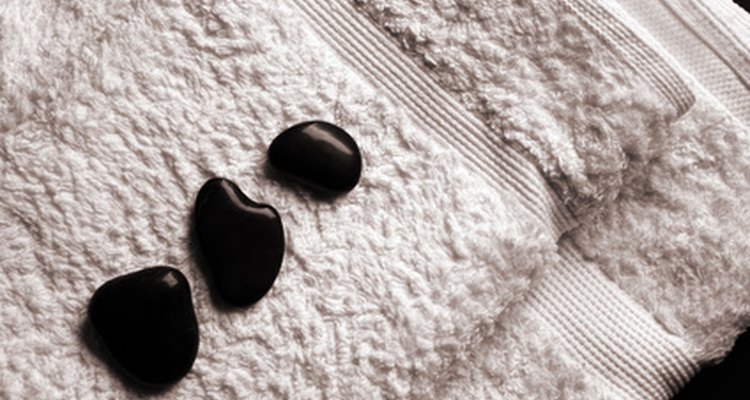 Las piedras negras destacan sobre las toallas blancas.