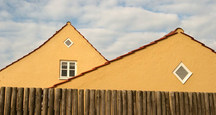 Remove dirt and grime from your wood fence with periodic cleaning.