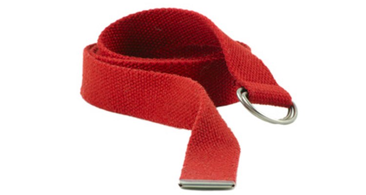 A double D-ring belt fastens by threading the loose end through the rings.