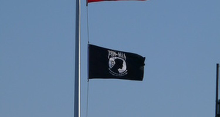 Flag poles use a single fixed pulley for raising and lowering flags.