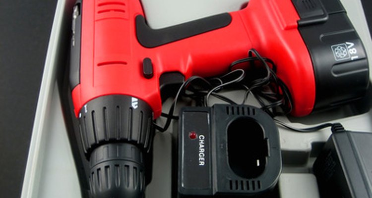 Use a cordless drill to drive treated deck screws to attach the bracket.