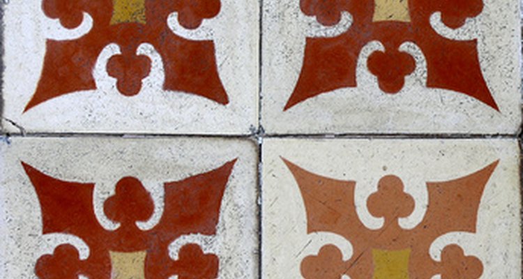 Paint designs on unglazed tiles to match your home's decor.