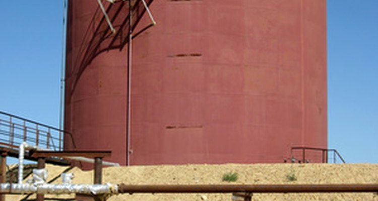 Large oil tanks require the use of a boom lift for painting.