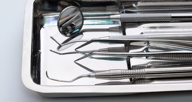 An orthodontic nurse assesses dental supplies and reorders stock.